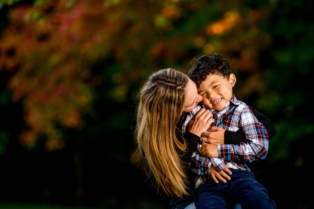 A mom and her son cuddle during a family photo shoot in the Catskills of NY