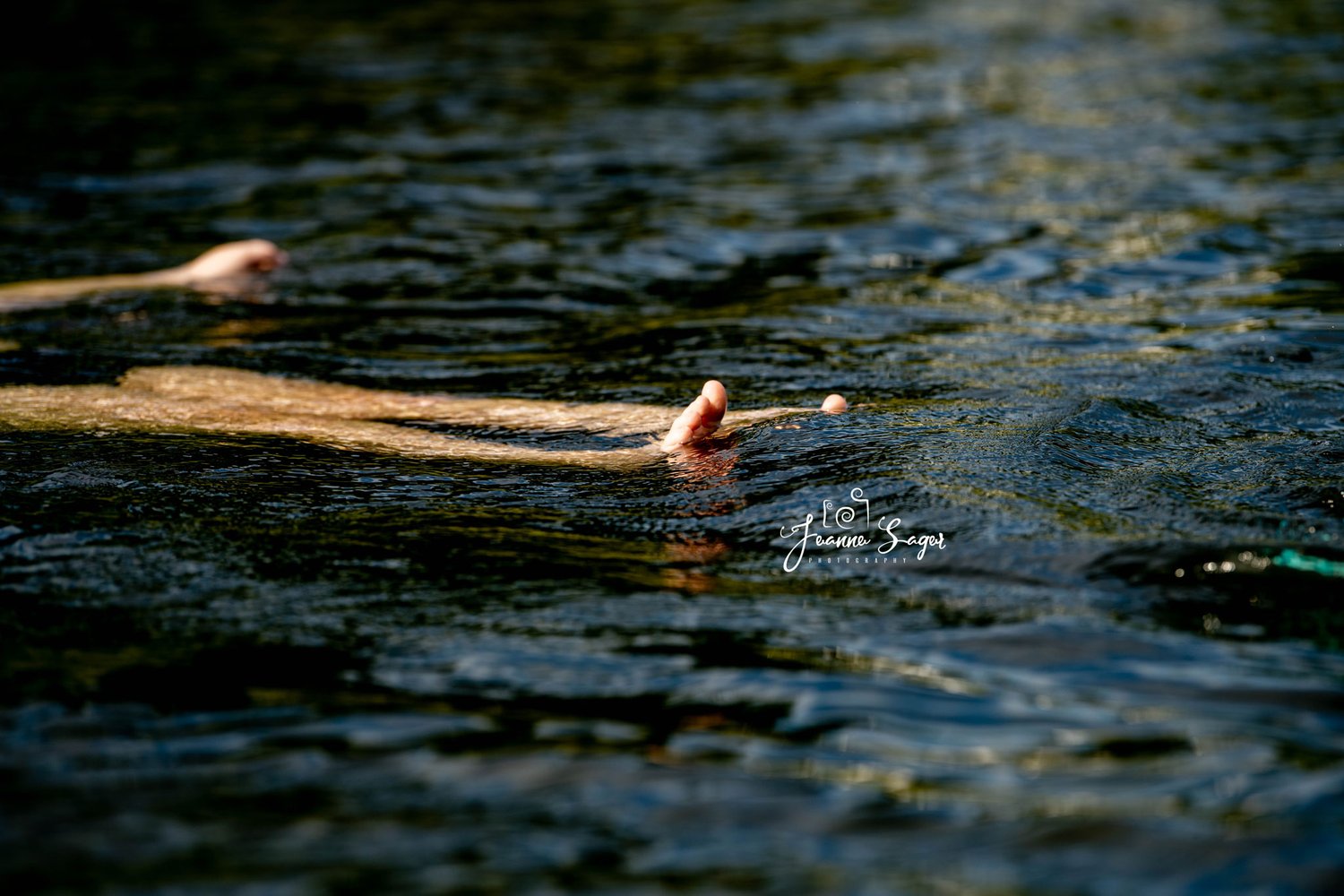 A child is seen floating in the Delaware River with toes sticking out of the water