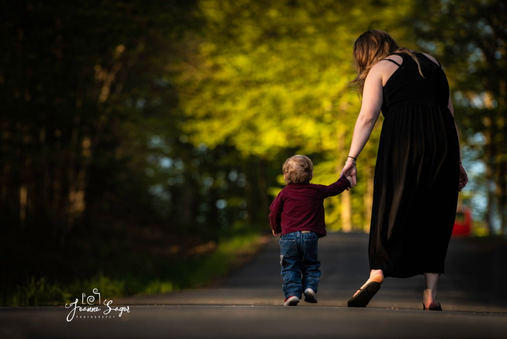 A mom and son walk hand in hand during fall family photo session in Roscoe NY
